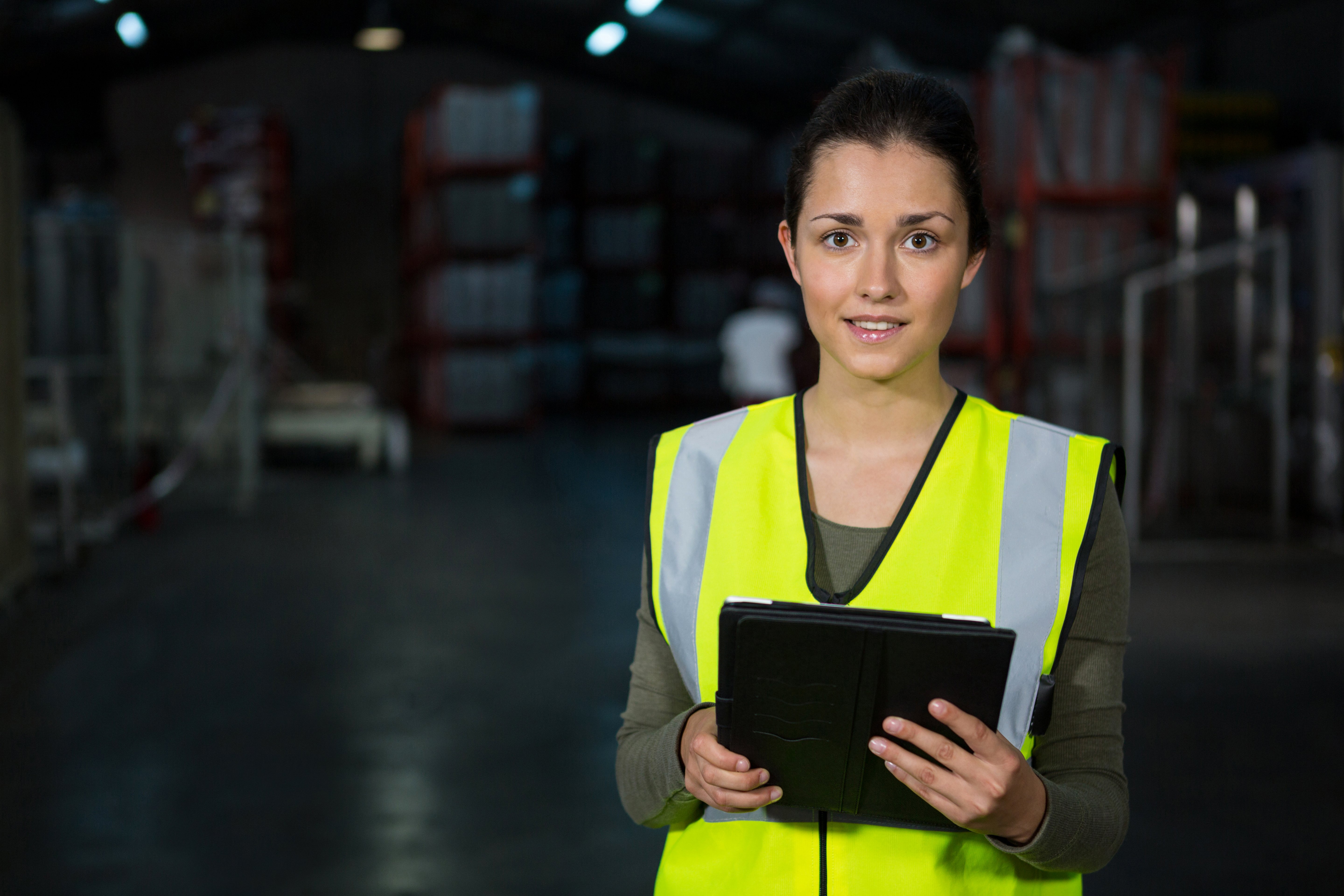 beautiful-young-woman-using-digital-tablet-factory