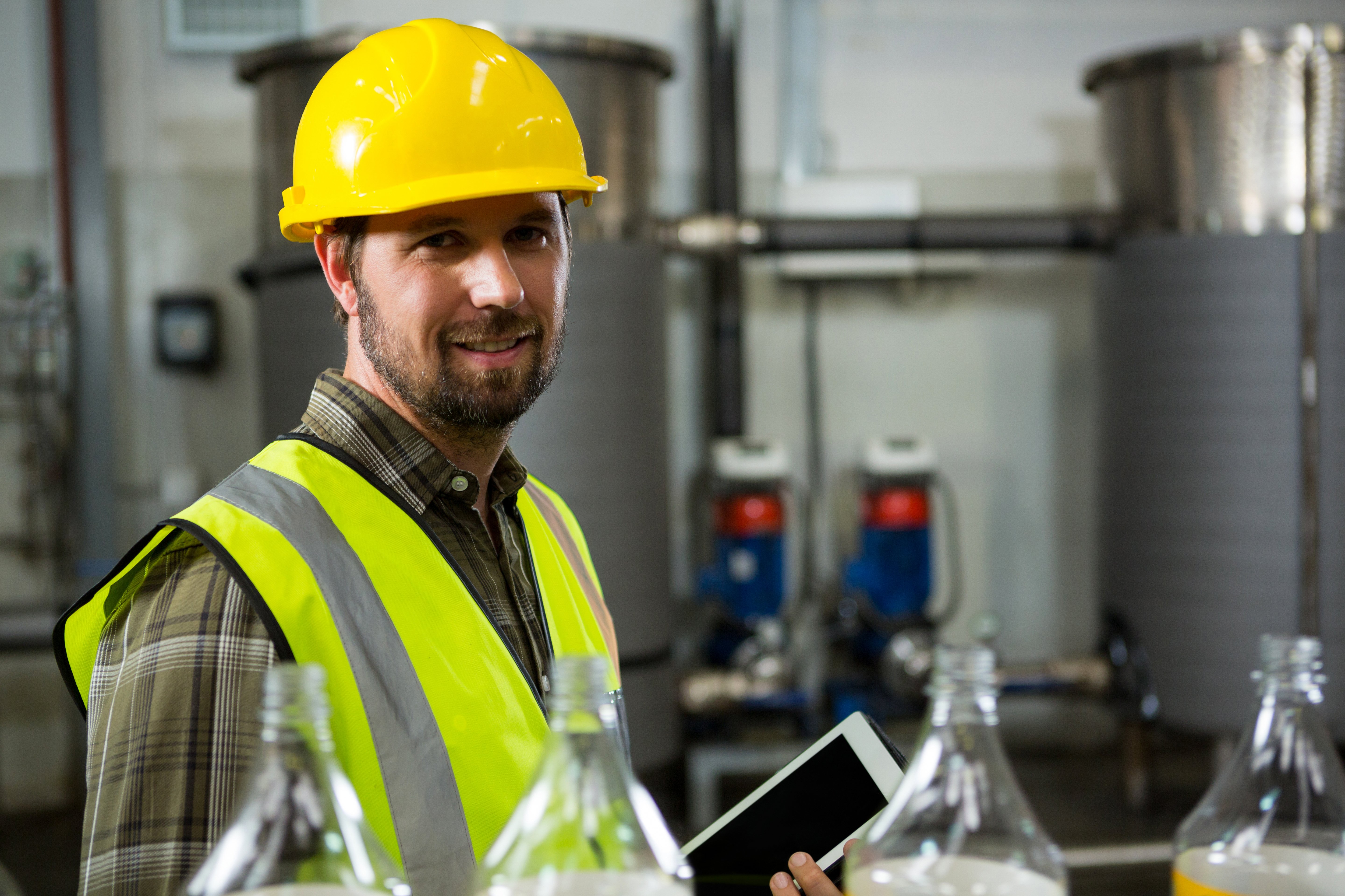 confident-male-worker-holding-digital-tablet-factory