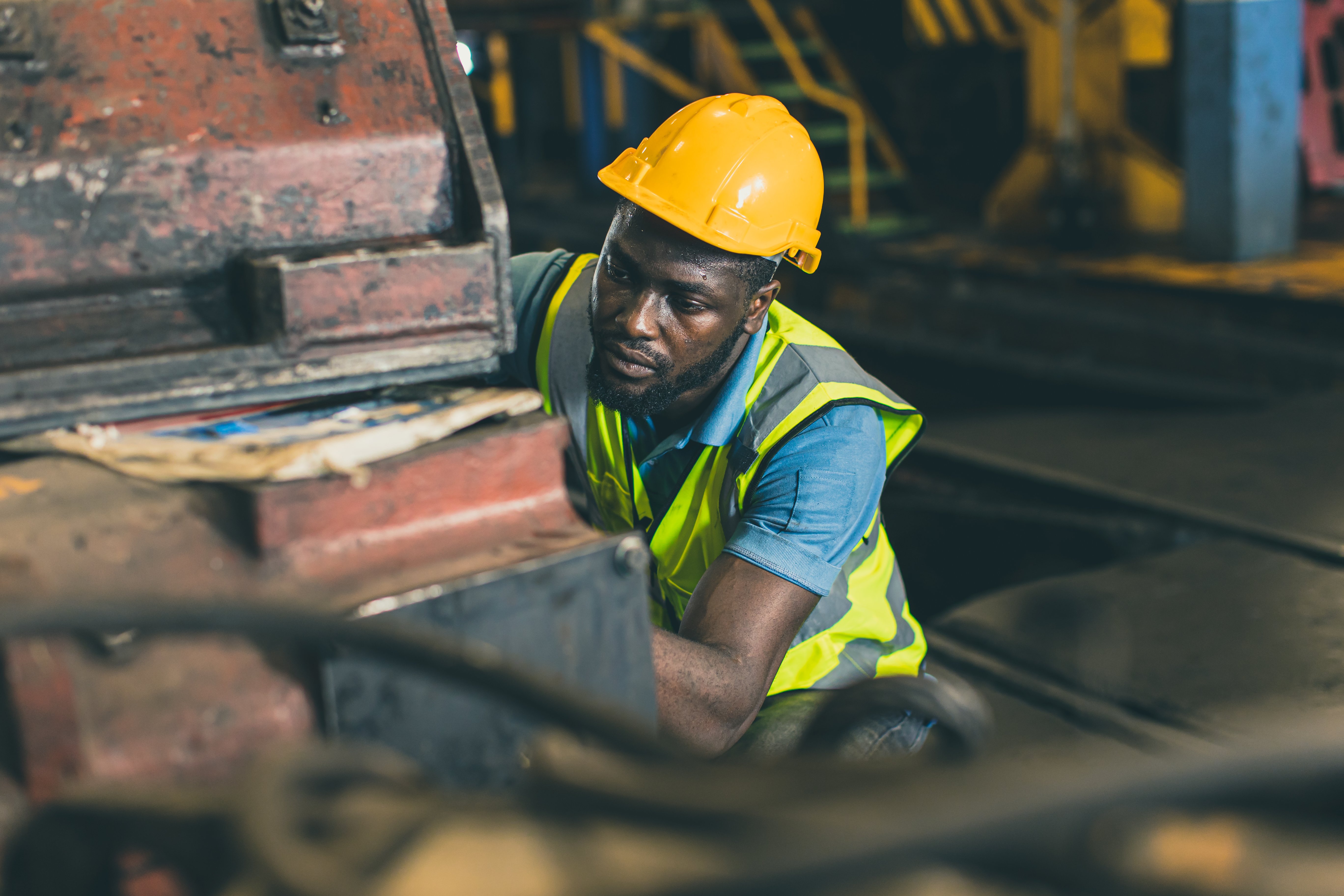 engineer-male-mechanic-staff-worker-labor-working-hevy-industry-dirty-work-place-servicing-large-machine