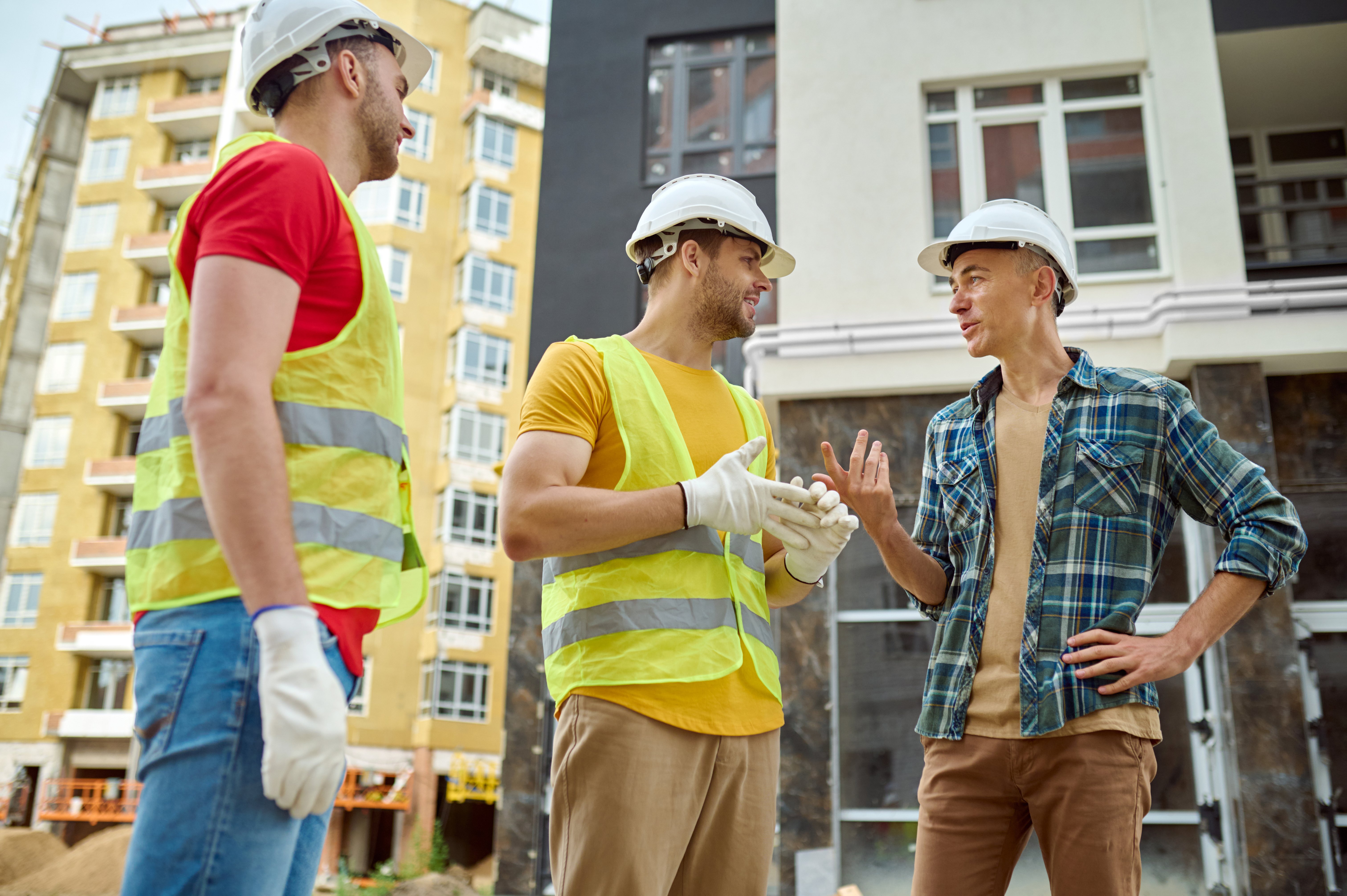 engineer-two-workers-communicating-construction-site