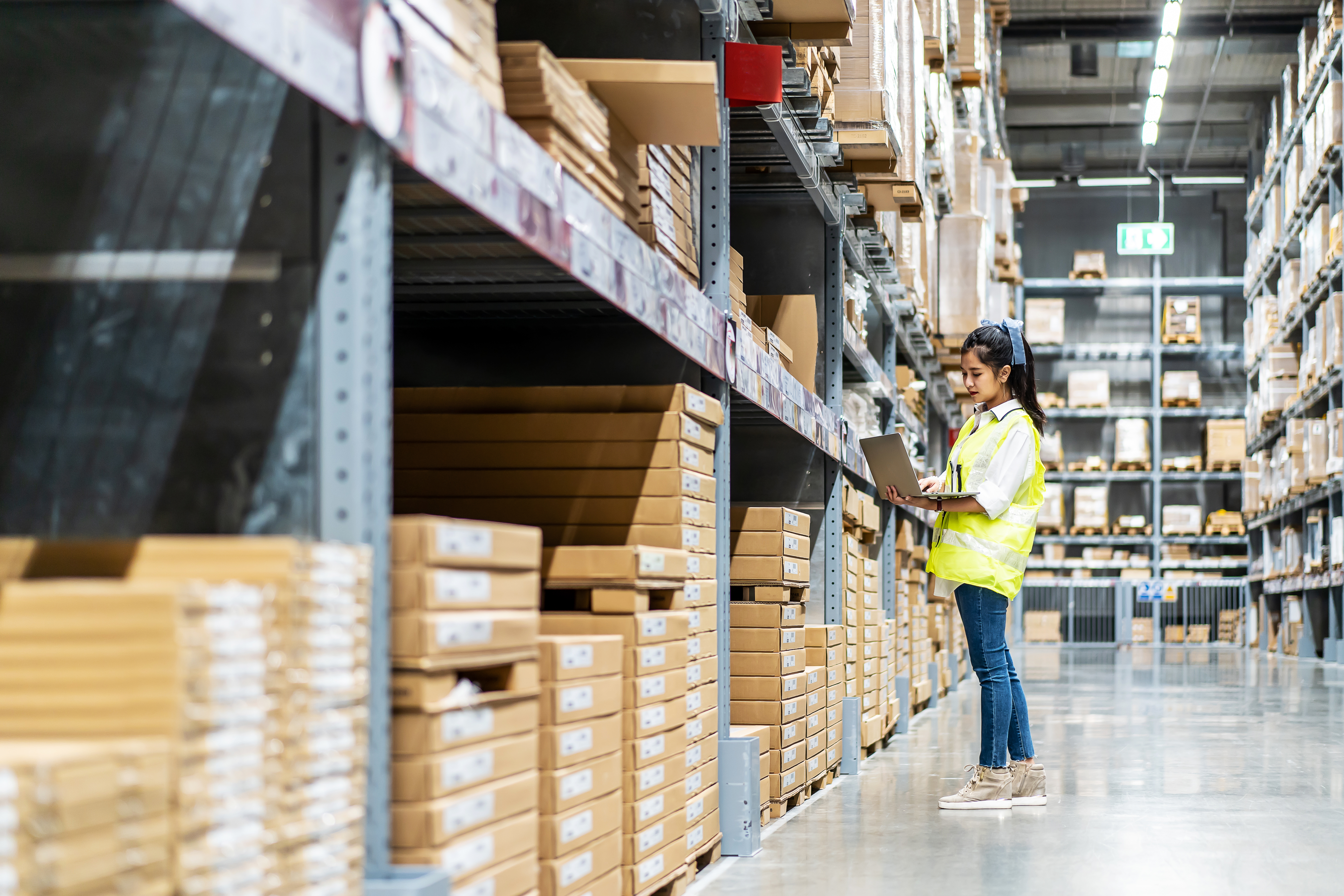 engineer-woman-check-stock-details-tablet-checking-boxes-with-logistics-warehouse