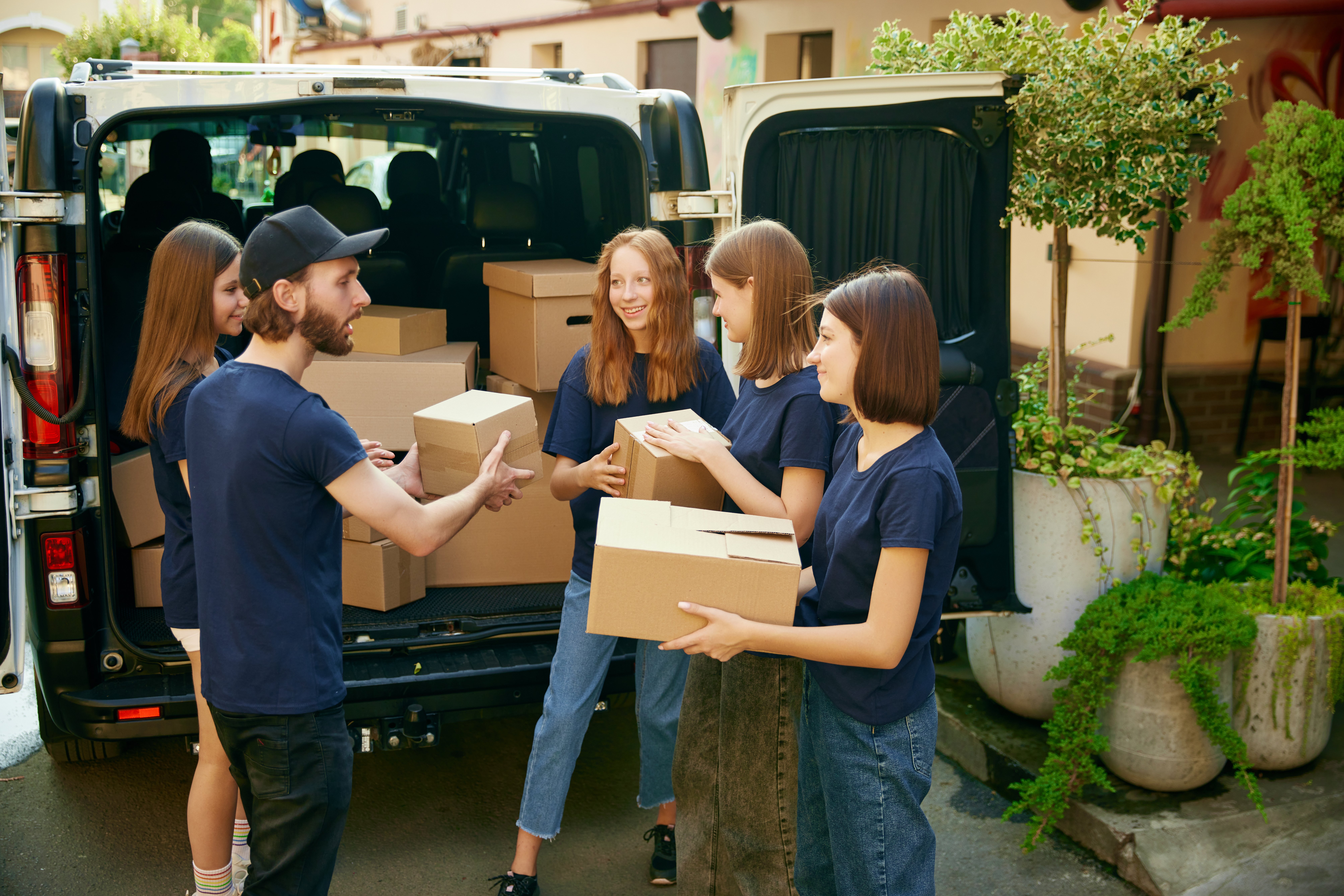 group-young-people-man-women-volunteers-loading-many-boxes-humanitarian-goods-into-van