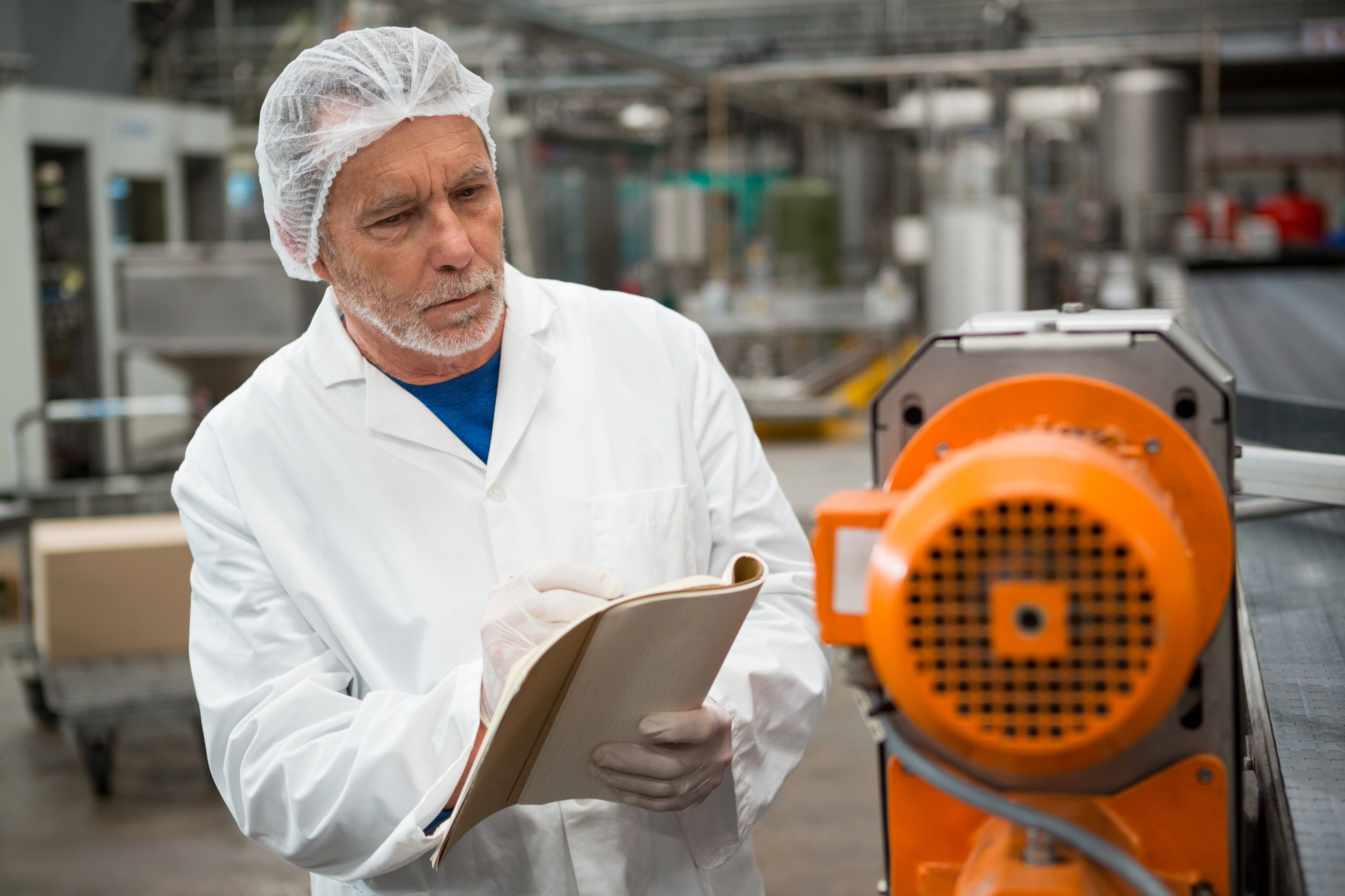 male-worker-inspecting-machines-cold-drink-factory