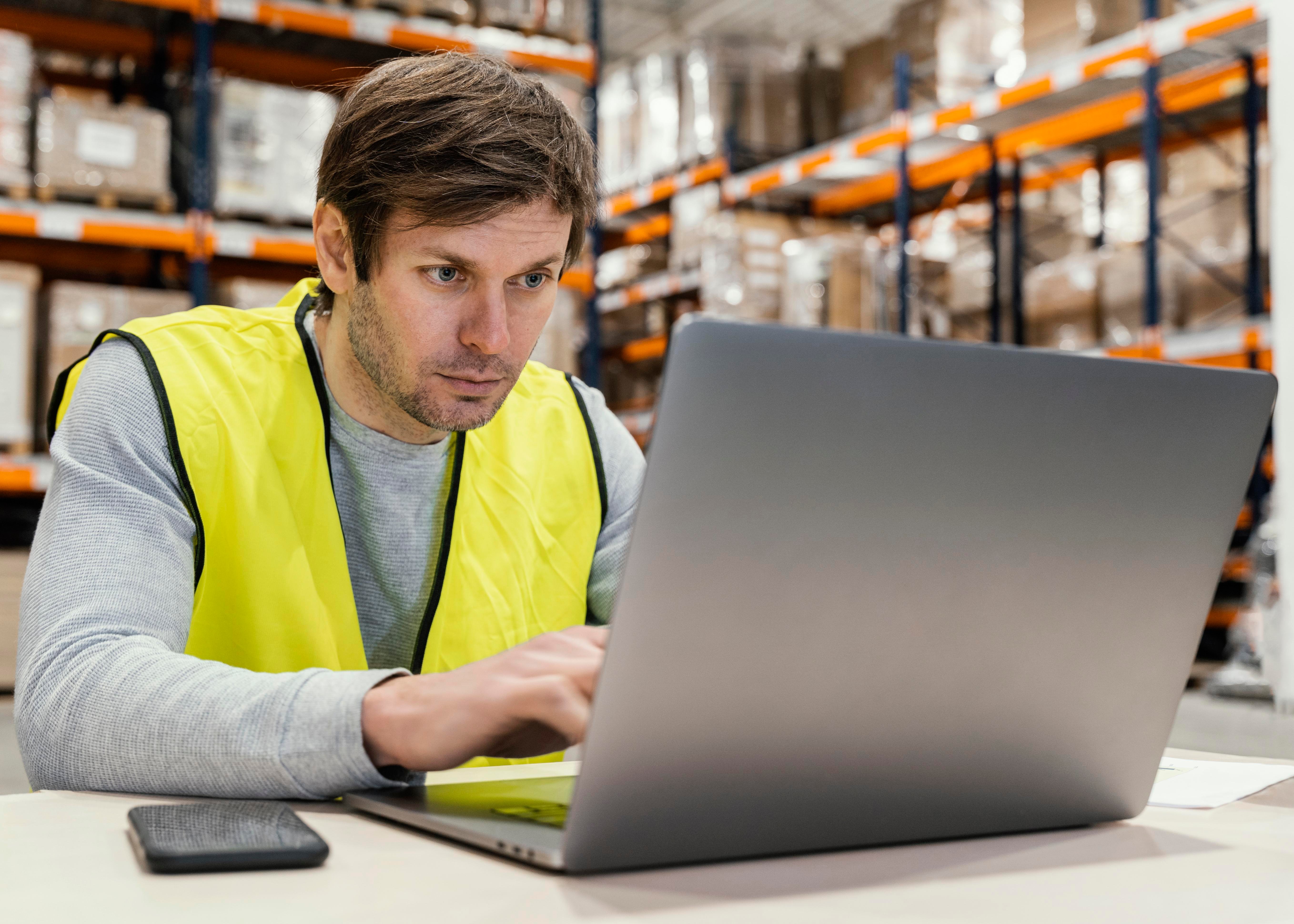 man-warehouse-working-laptop