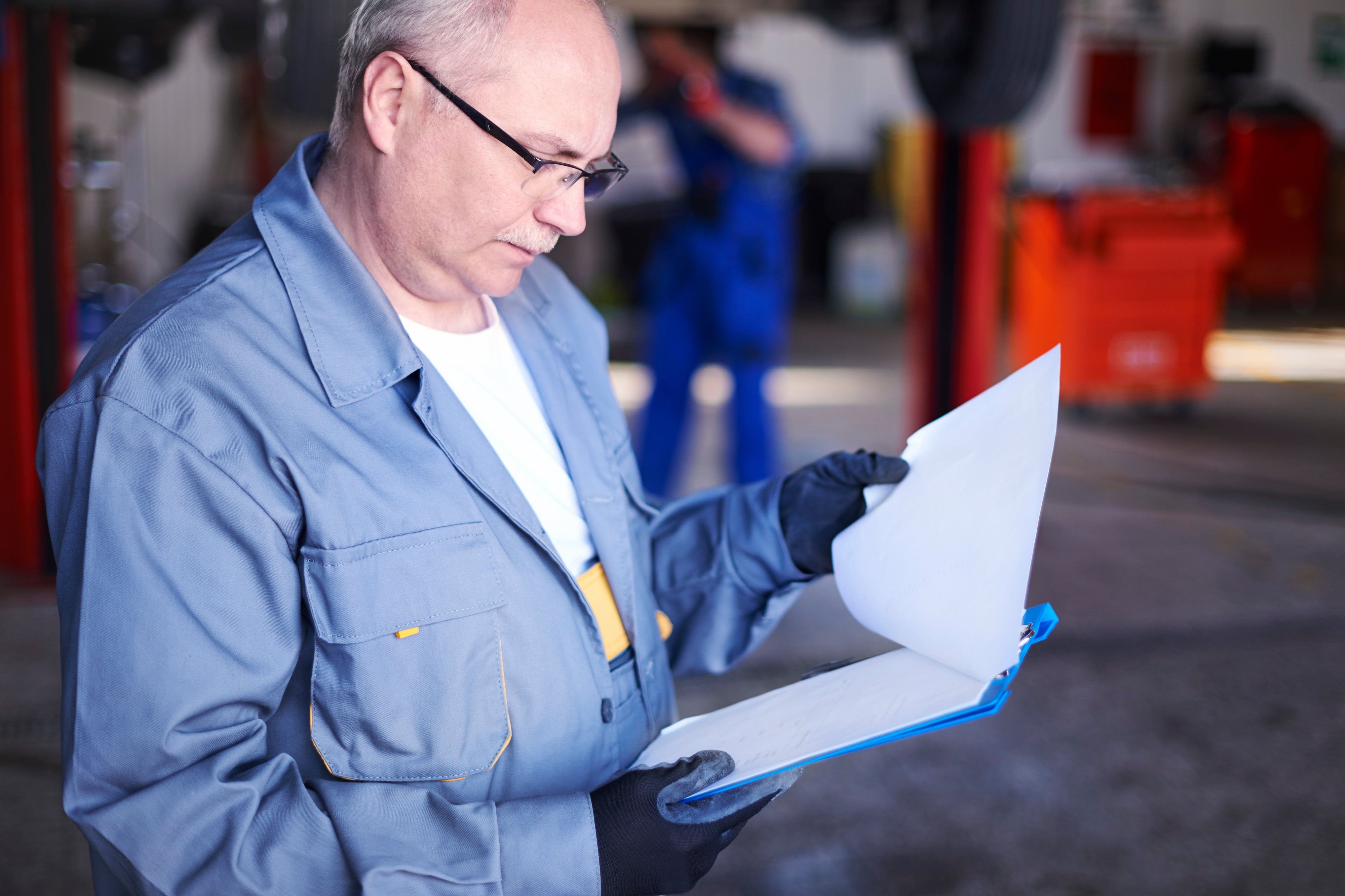 mechanic-checking-car-report