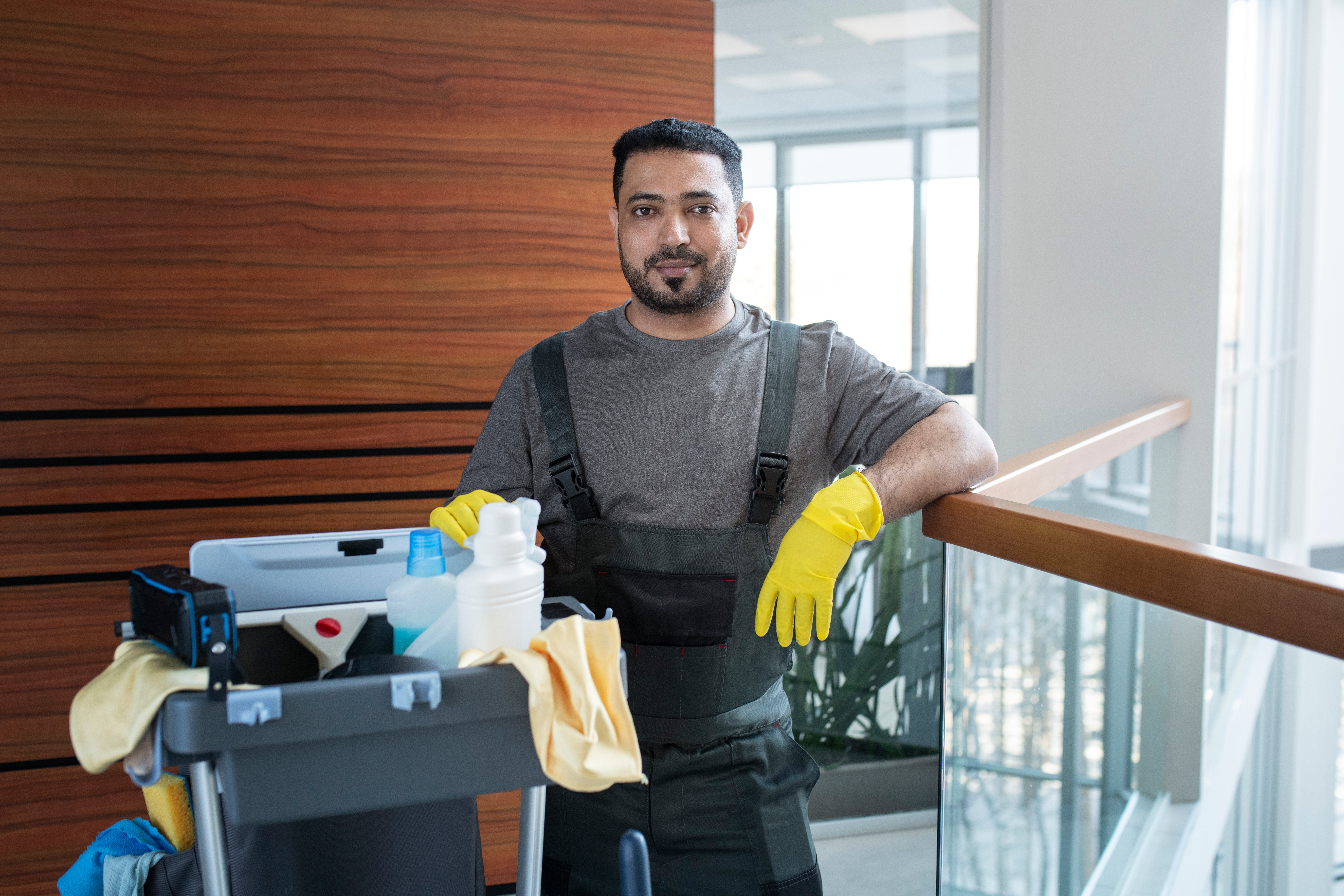 medium-shot-smiley-man-with-cleaning-cart