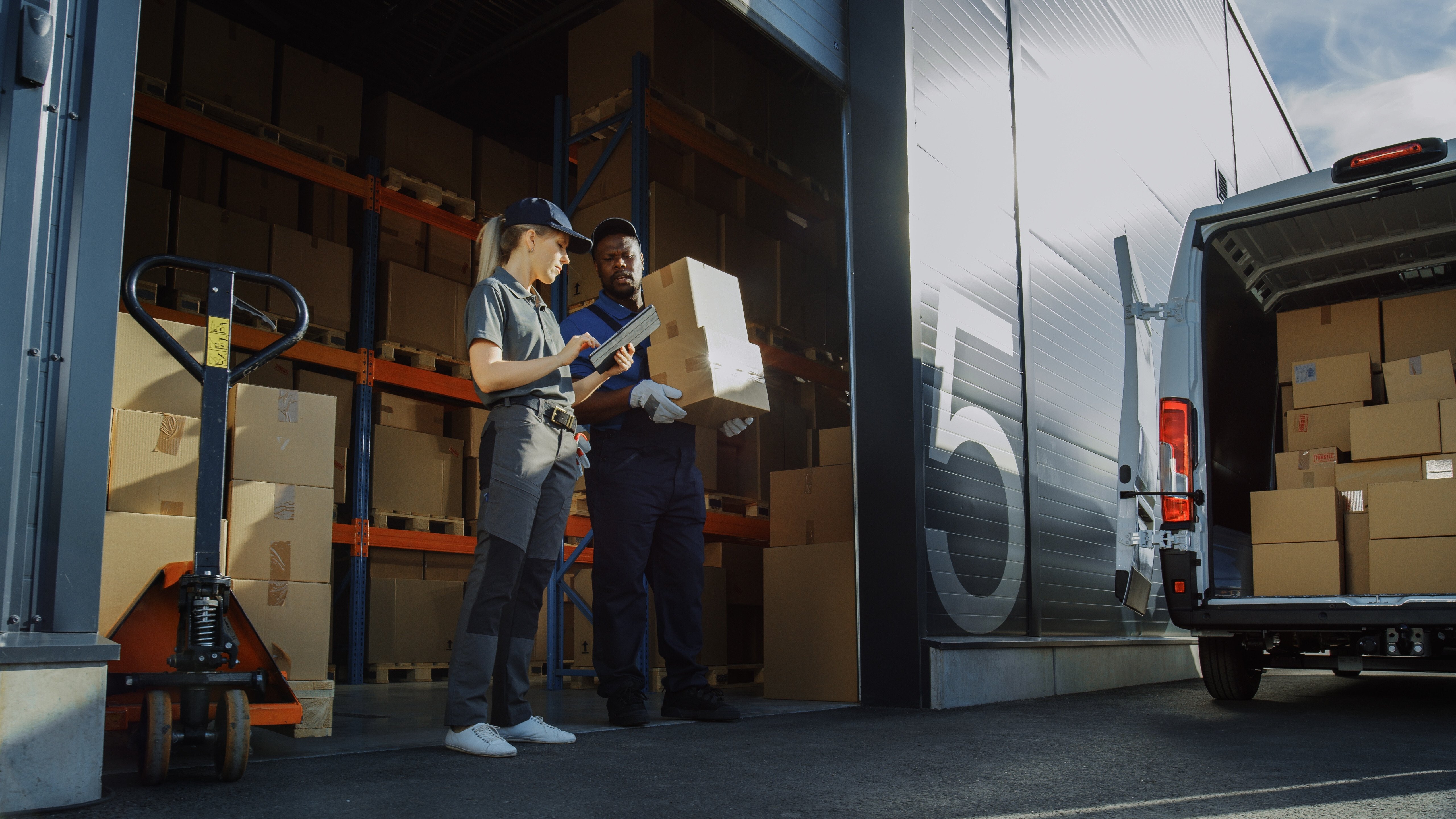 outside-logistics-distributions-warehouse-with-manager-using-tablet-computer-diverse-workers-loading-delivery-truck-with-cardboard-boxes-online-orders-purchases-ecommerce-goods