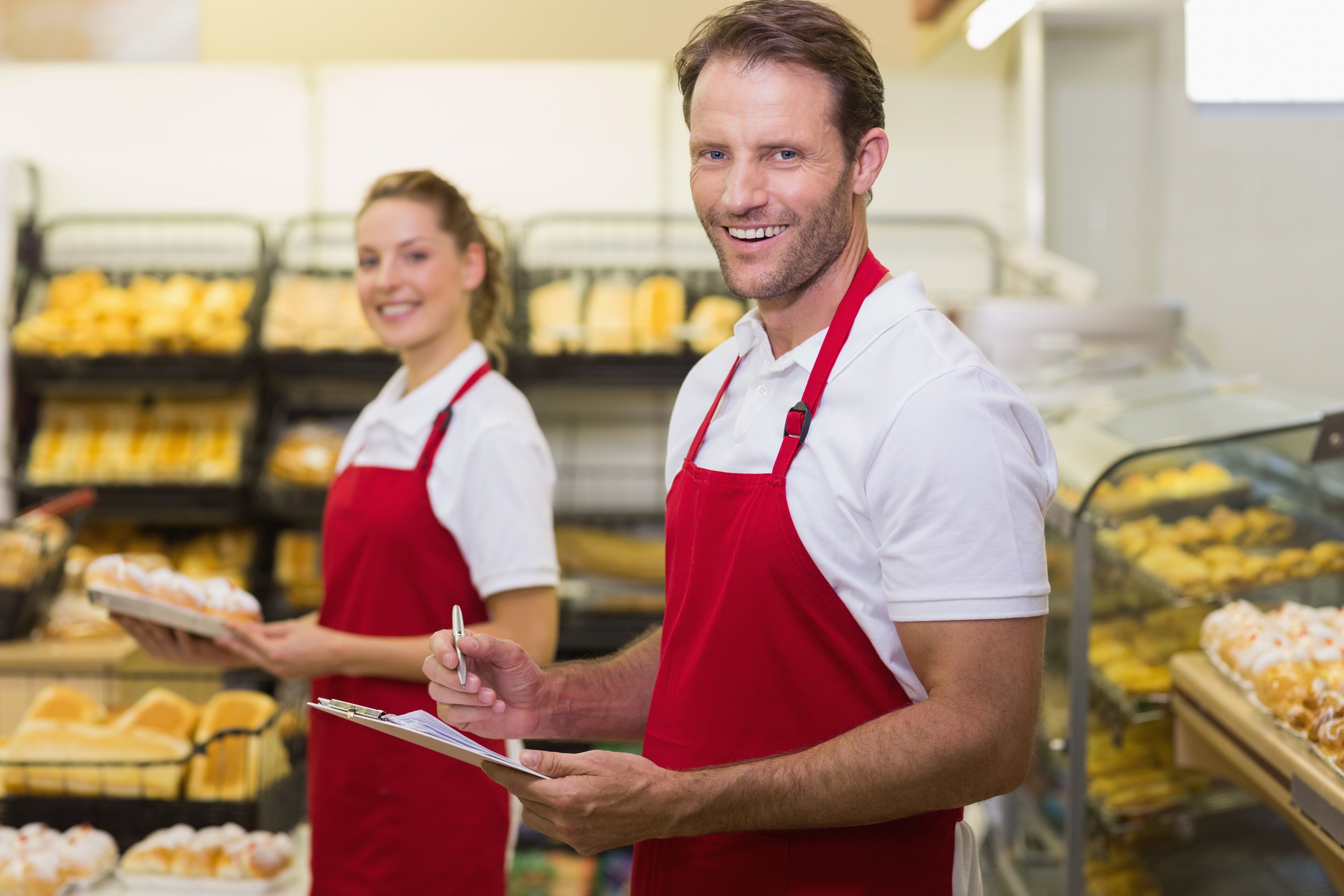 portrait-two-smiling-bakers-looking-camera