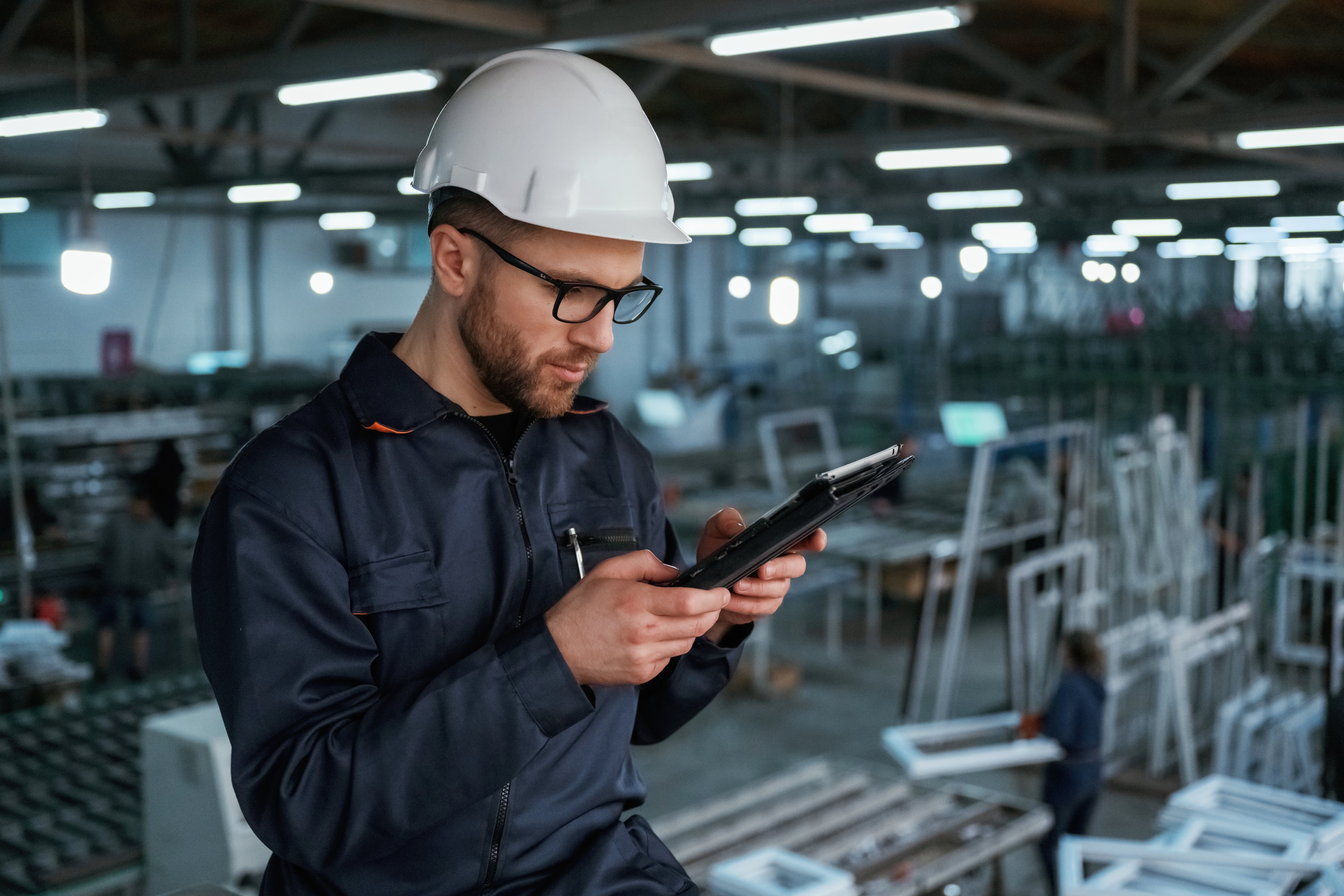 reading-data-from-tablet-factory-worker-is-indoors-with-hard-hat