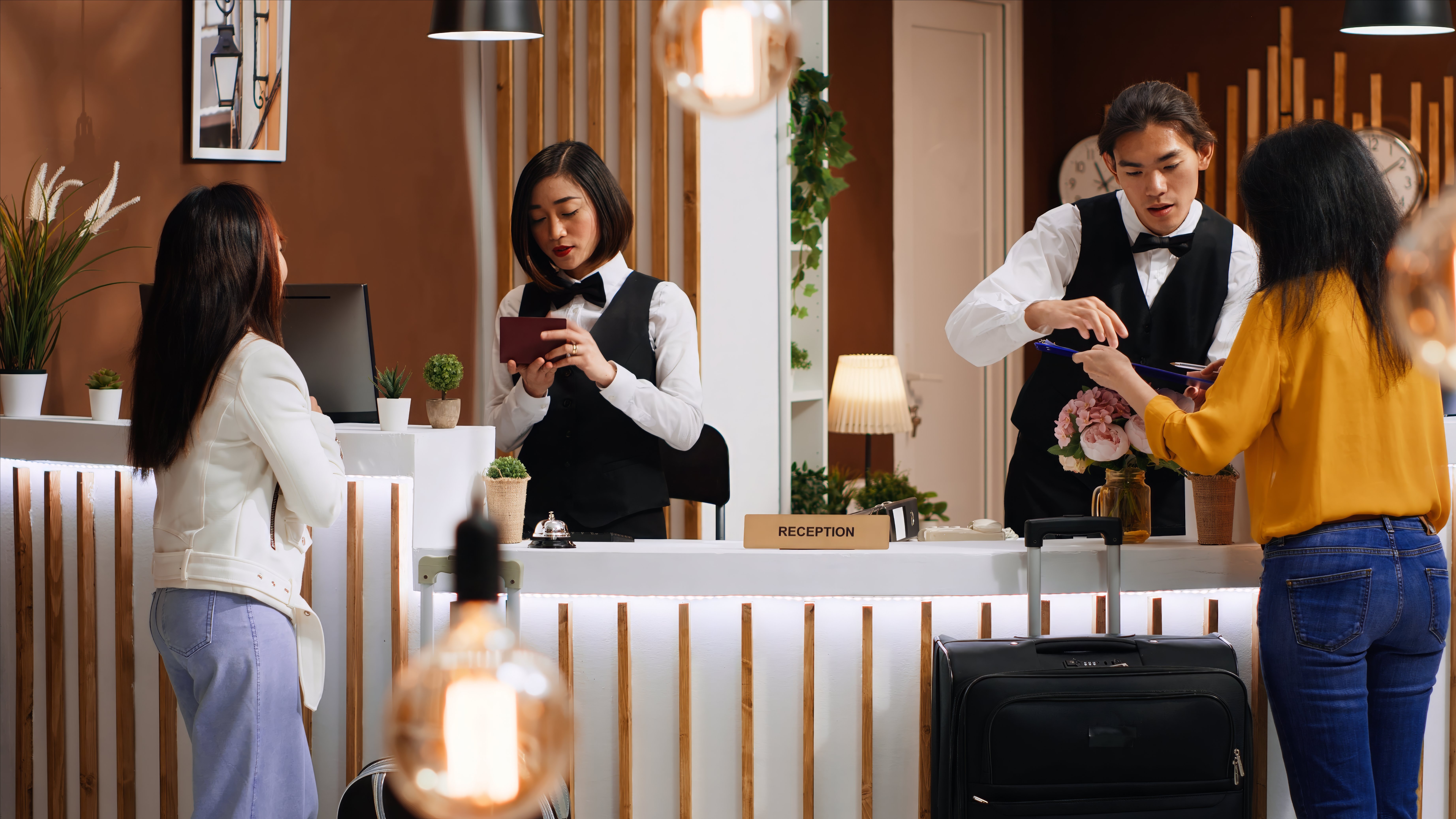 tourists-going-through-check-process-hotel-reception-desk