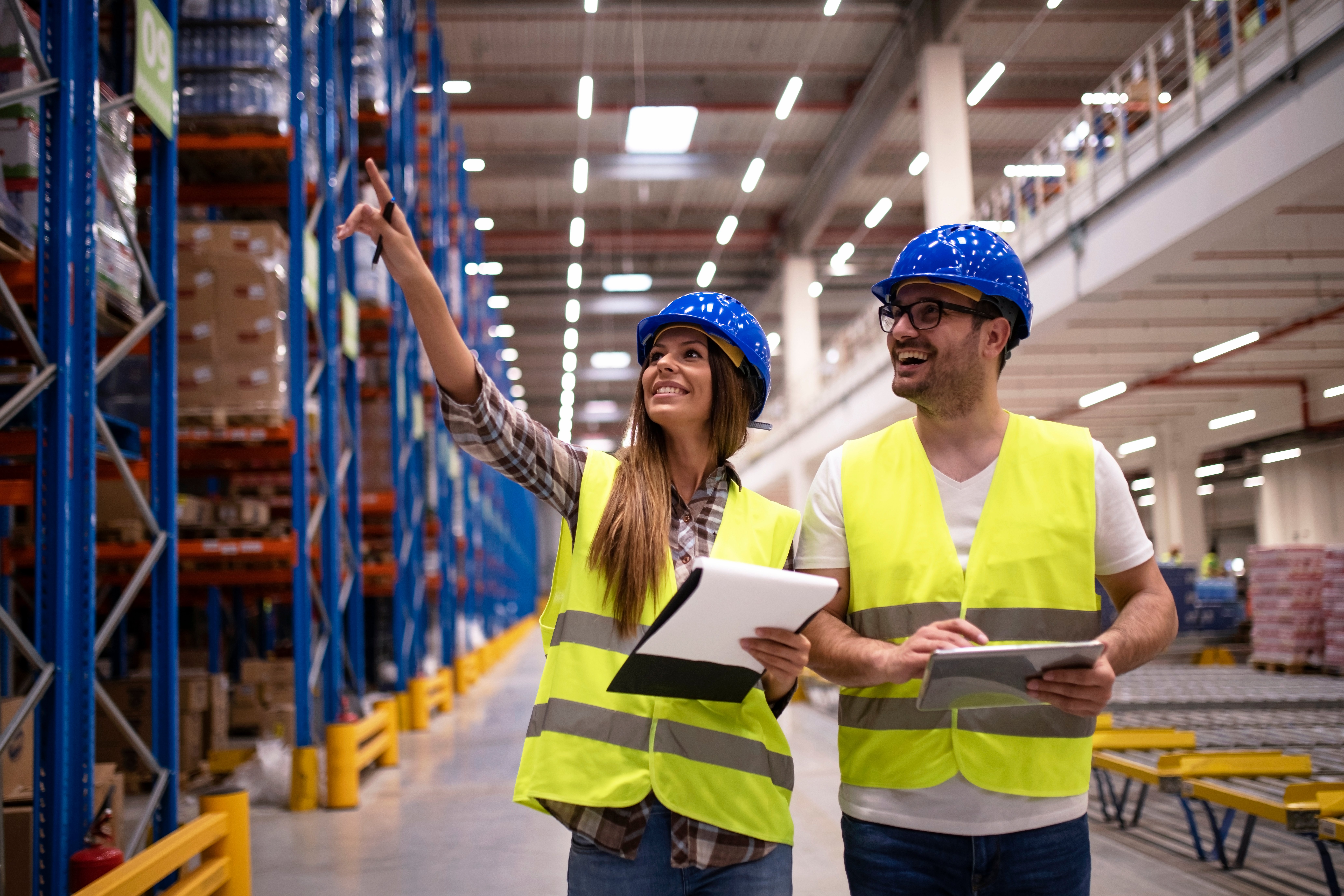 warehouse-workers-protective-uniform-walking-through-large-distribution-center-organizing-goods-distribution