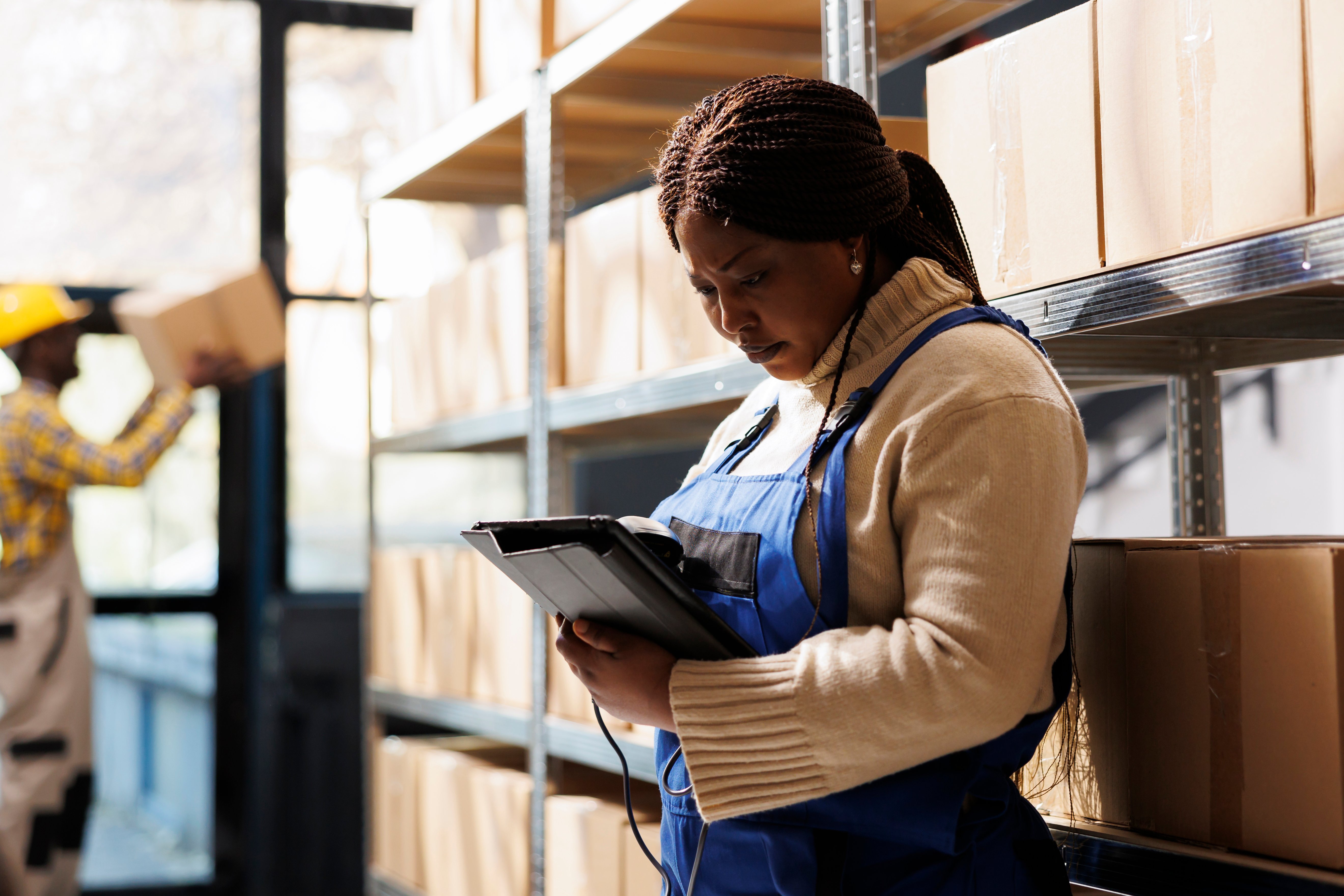 woman-supervising-supply-using-barcode-scanner-digital-tablet