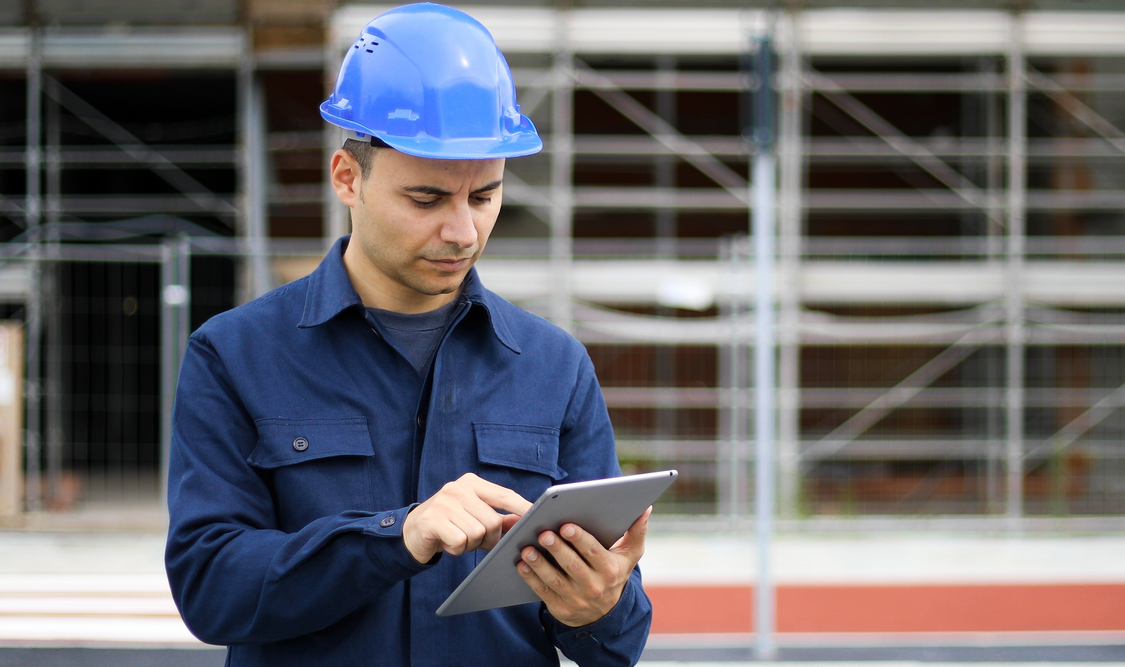 young-engineer-man-suit-helmet-working-tablet-pc